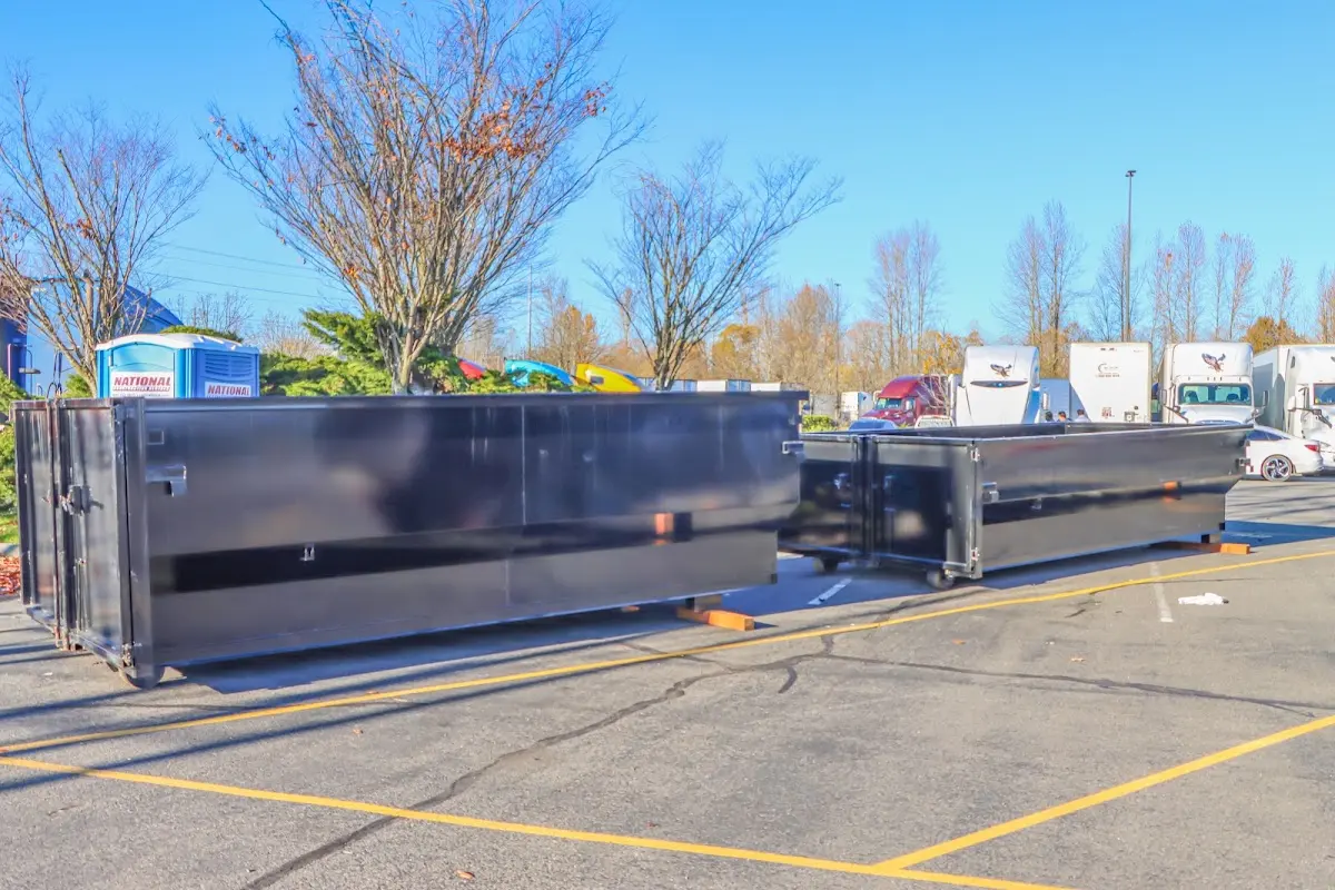 Professional dumpster rental service with roll-off container on residential driveway in Loyalsock